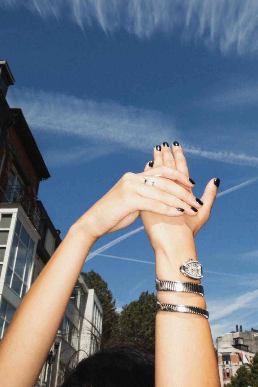a woman raises her hand wearing a Repossi Serti sur Vide ring in white gold